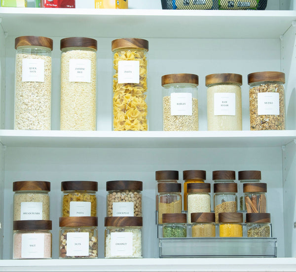 Shelving unit with labeled jars containing various food items