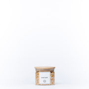 Round Glass Bamboo Storage Jar with lid filled with popcorn kernels, ideal for pantry organisation. Perfect for kitchen storage solutions.