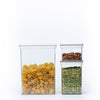 Clear airtight stackable containers in three sizes with pasta, peas and almonds against a white background