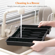 Hands rinsing Expandable Cutlery Drawer Organiser Tray – Black (7 Slot) at kitchen sink for efficient storage organisers.