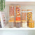 Clear pantry jars with bamboo lids for home organisation and pantry storage, featuring assorted dry foods. Storage Organisers Australia.