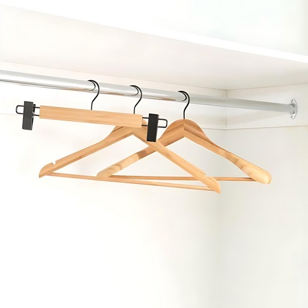 Bamboo coat hangers with black matte hooks for home organisation in a closet; ideal for space-saving and stylish storage solutions.