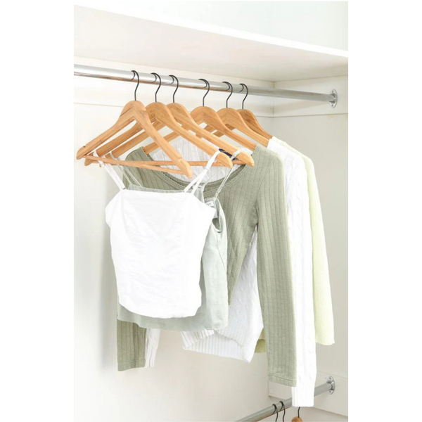 Bamboo coat hangers with black matte hooks in closet, perfect for home organisation, space-saving storage, and stylish wardrobe display.