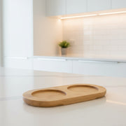 Bamboo Tray for Round Bottles – 500 ml placed on kitchen counter, ideal for storage organisers and enhancing kitchen organisation.