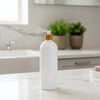 White Bathroom Pump Bottle – 1 L Refillable Dispenser on a kitchen counter for efficient storage and organisation.
