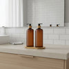 Amber Plastic Pump Bottles + Bamboo Tray – 500 ml Set on a bathroom counter, ideal for stylish kitchen or pantry organisation.