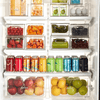 Clear fridge organisers filled with fruits, vegetables, and drinks for efficient home organisation in Australia.