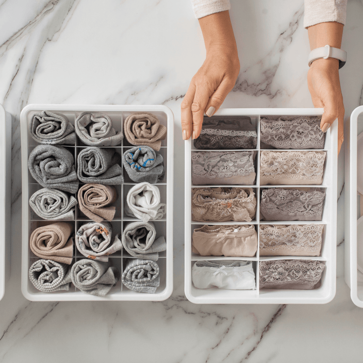 Drawer dividers for efficient home organisation with neatly folded clothing items.