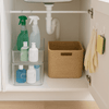 Under-sink storage with cleaning supplies, storage baskets, and hooks for home organisation.