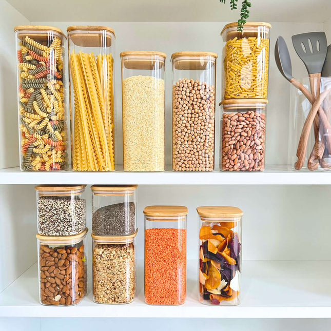 Square Bamboo Pantry Jars – 12-Pack Glass Storage Set showcasing dried goods for kitchen organisation on white shelves.