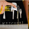 Hand pouring oil from a bottle with a nozzle onto a surface, against a black background with white text.