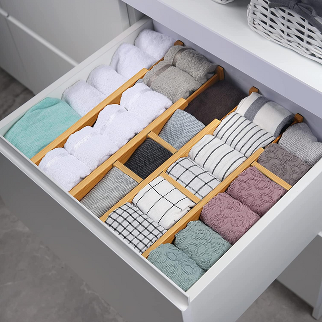 Bamboo Expandable Drawer Dividers organising towels in a kitchen drawer, showcasing effective storage organisers for neat kitchen organisation.