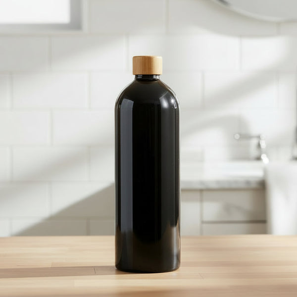 Black bottle with a wooden cap on a kitchen counter