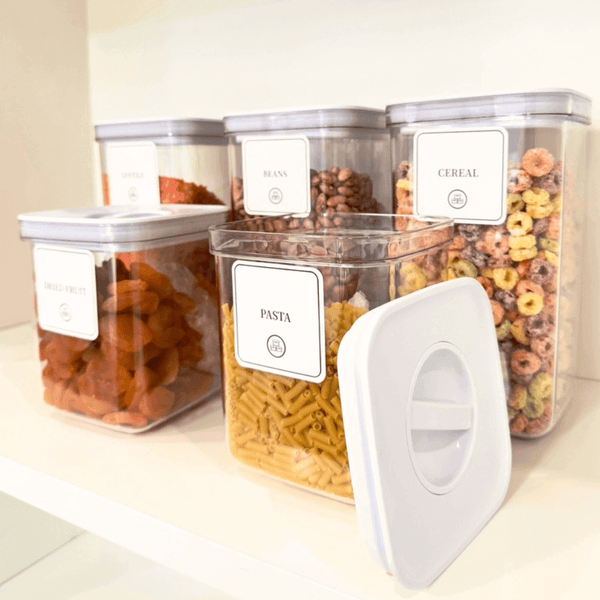 White airtight containers with twist lock for kitchen storage, featuring pasta, beans, and cereal. Ideal for home organization, pantry storage.
