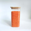 Square bamboo glass pantry storage container filled with red lentils, perfect for kitchen organisation.