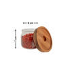 Round glass acacia storage jar with wooden lid, ideal for kitchen pantry organization and stylish home storage solutions.