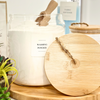 Jar of washing powder with a wooden lid on a surface