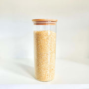 Glass jar from Round Bamboo Glass Pantry Container Set – 35 Pack used for storing rice in kitchen pantry.