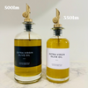 Round Glass Oil & Vinegar Bottle – 350ml Dispenser with stainless steel spout, next to 500ml bottle, on marble surface