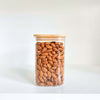 Square bamboo glass pantry jar filled with almonds, ideal for storage and organization.