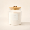 A clear glass jar filled with white napkin paper, featuring a light wood lid with a rope handle and a white label that reads 'NAPISAN'.