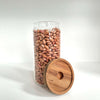 Round glass storage jar with acacia lid, filled with beans; ideal for pantry organization.