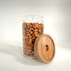 Round glass storage jar with acacia lid, ideal for pantry organization and space-saving.