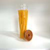 Round glass storage jar with acacia lid, filled with pasta, ideal for pantry organization.