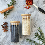 160ml Herb & Spice Jar with Bamboo Lid ideal for kitchen organisation, shown with herbs and spices on a marble countertop.