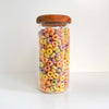 Acacia lid glass jar filled with colorful cereal, perfect pantry storage organizer.