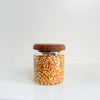 Acacia glass jar filled with popcorn kernels, ideal for pantry storage and space-saving organization.