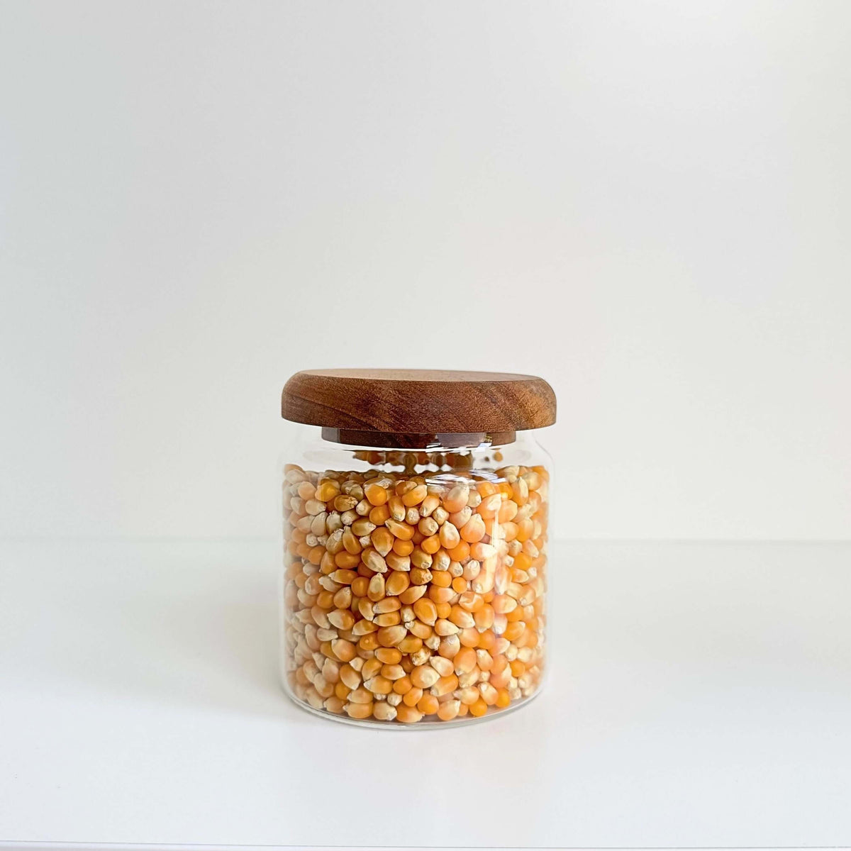 Acacia Lid Glass Jar Small Pantry Organisation 15 Pack holding popcorn kernels, perfect for pantry organisation and kitchen storage.