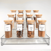 Acrylic spice rack with 12 bamboo-lidded jars for stylish kitchen organisation. Perfect pantry storage solution for spices.