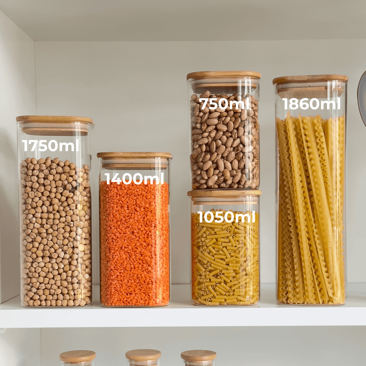 Square Bamboo Glass Pantry Jar Set – 5 Stackable Sizes displayed with lentils and pasta in a kitchen pantry for efficient pantry organisation.