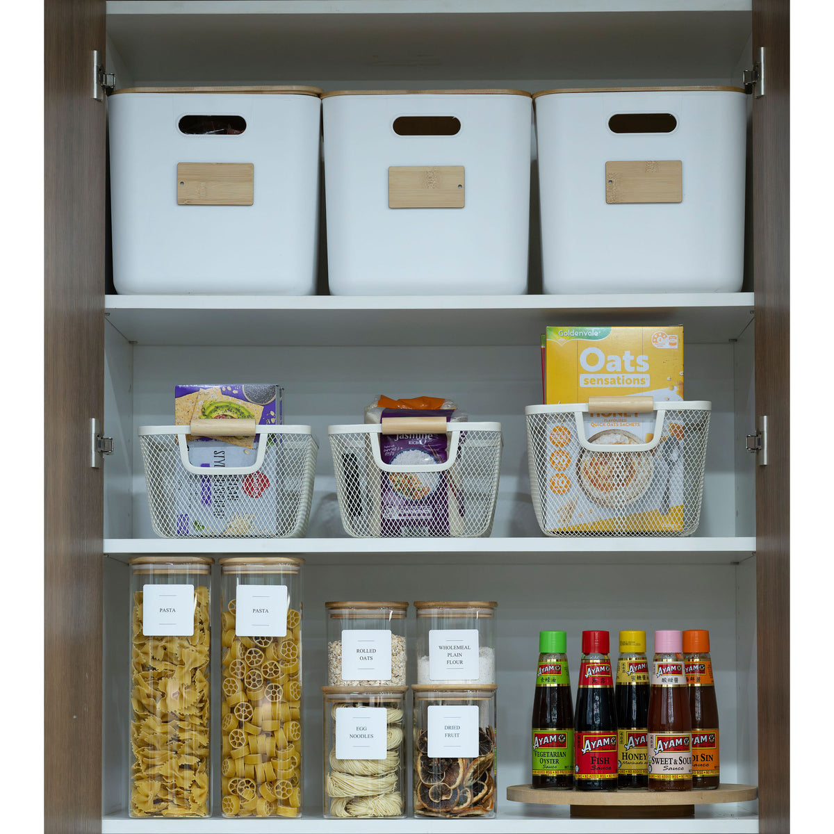 Pantry organised with the New Home Set Up Pack featuring storage organisers, including baskets and glass jars for efficient kitchen use.