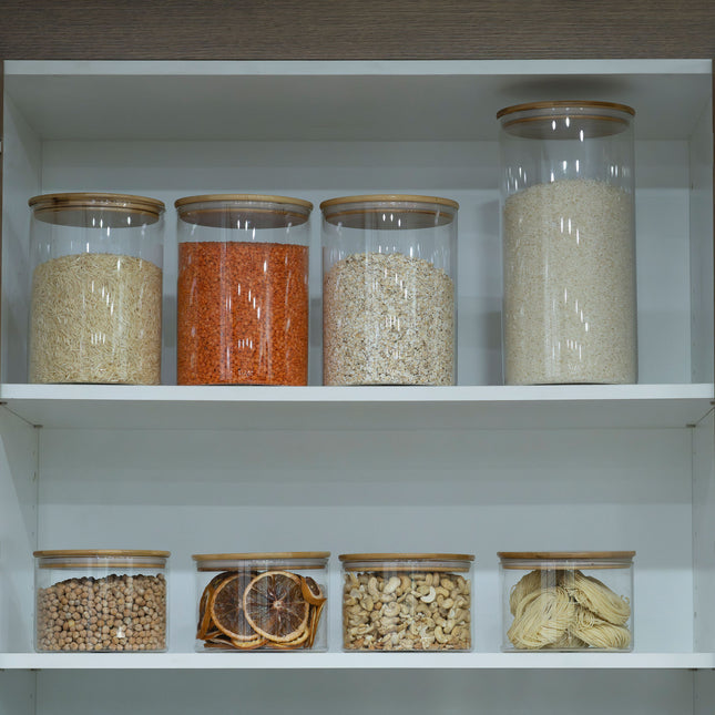 Glass jars on a shelf with grains and legumes, ideal for pantry organisation in a New Home Set Up Pack. Enhances kitchen storage.