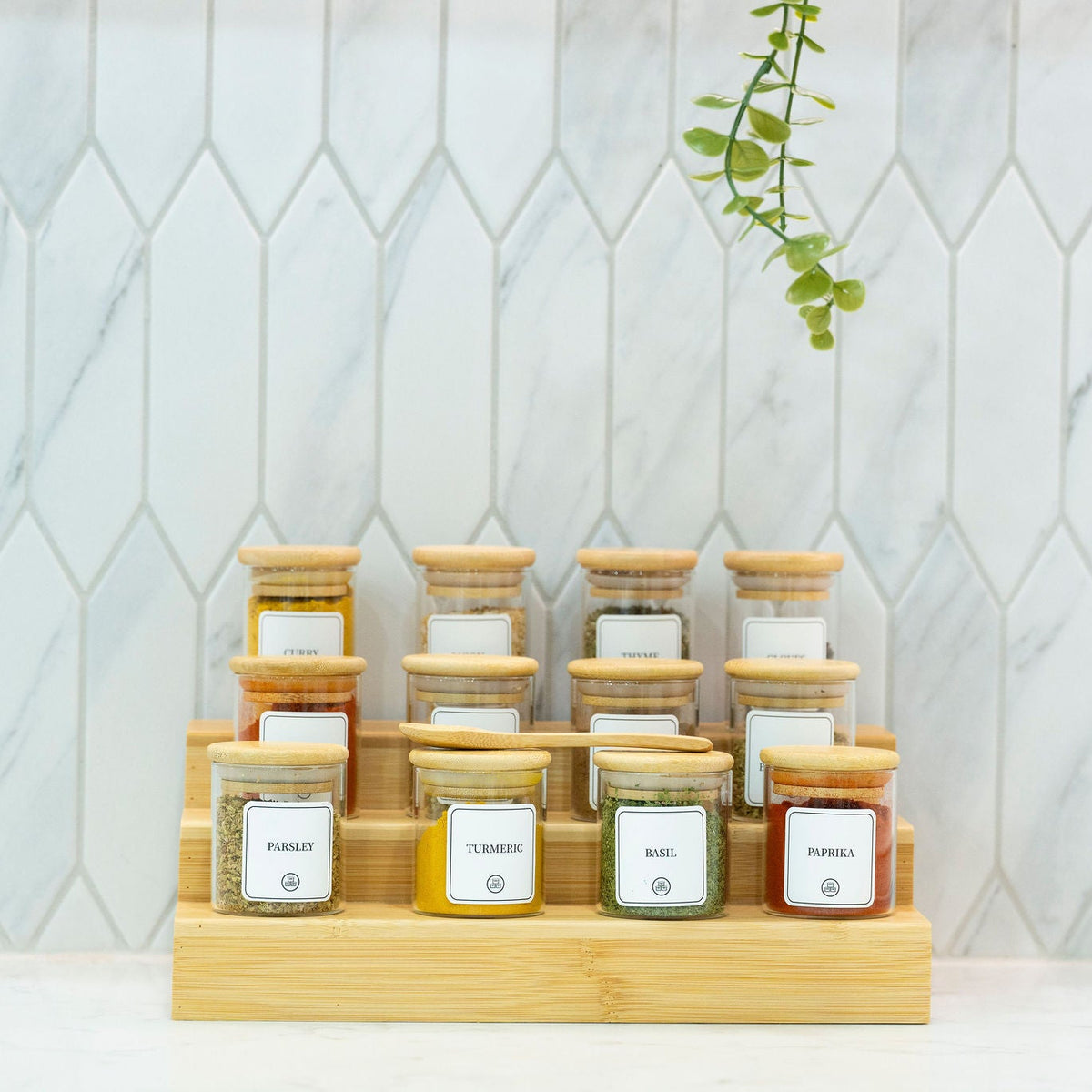 Round Glass Spice Jars with Bamboo Lid – 3 Sizes displayed on a kitchen counter for pantry organisation and efficient storage use.