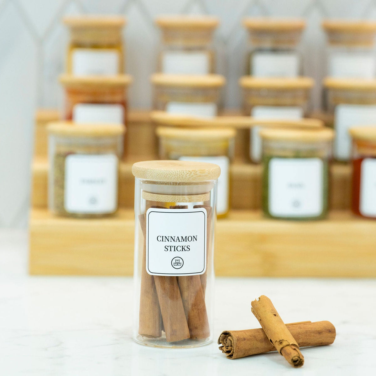 Round Glass Spice Jars with Bamboo Lid – 3 Sizes used for storing cinnamon sticks in kitchen pantry for effective organisation.