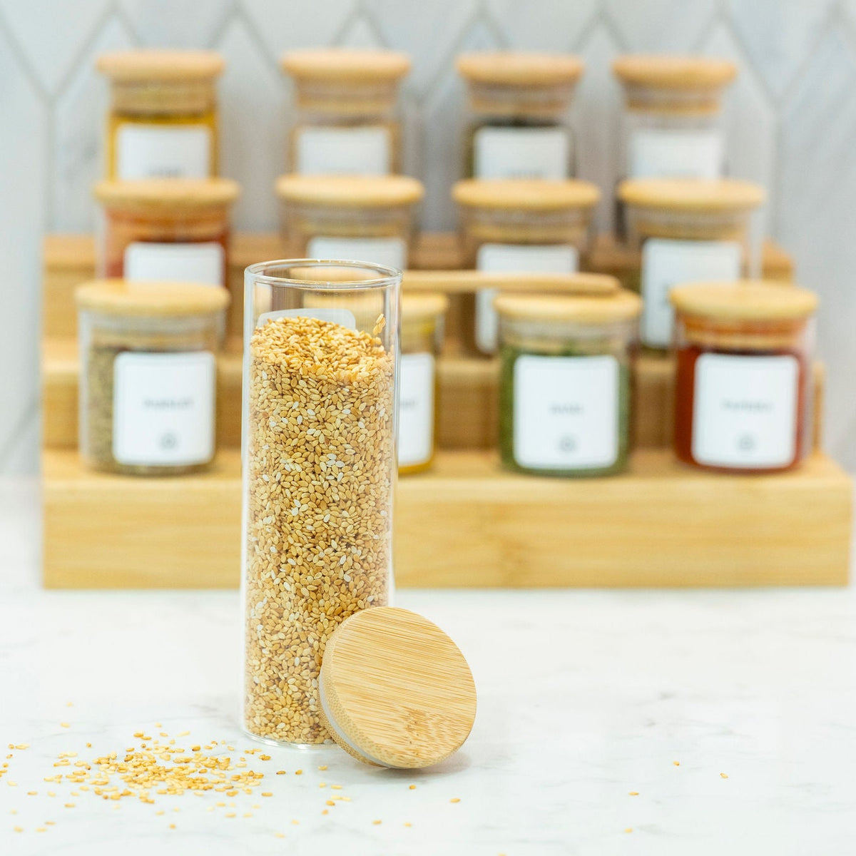 Round Glass Spice Jars with Bamboo Lid – 3 Sizes displayed on a marble countertop, perfect for kitchen and pantry organisation.