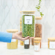 Glass jar filled with lentils, perfect for kitchen organisation. Round Glass Bamboo Storage Jars – 8 Sizes for efficient pantry storage.