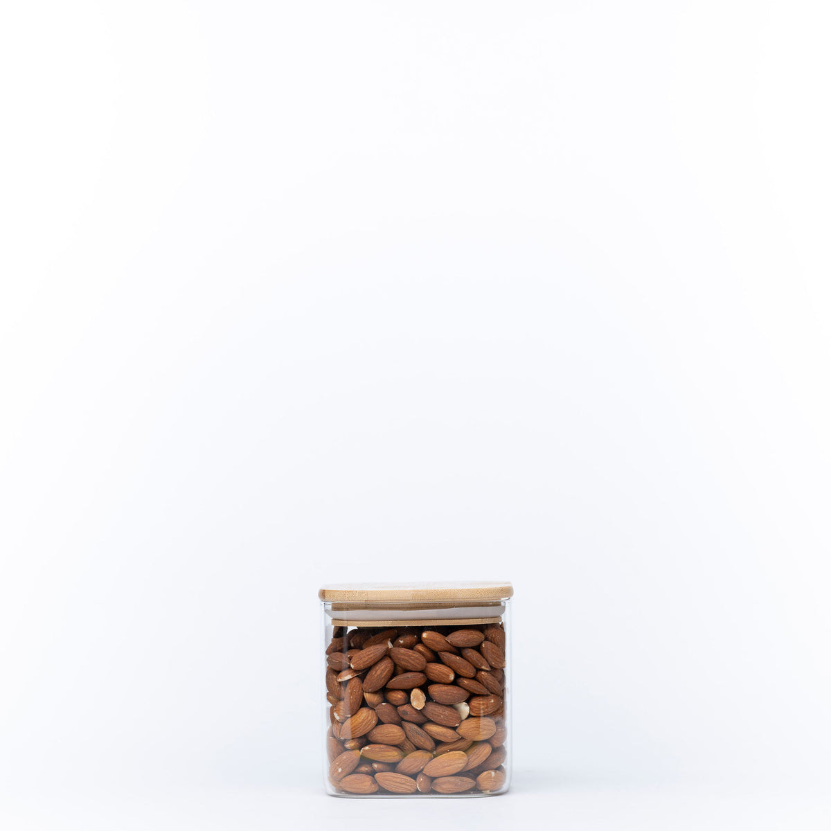 Square Glass Jar with Bamboo Lid – 750ml Pantry Storage filled with almonds for kitchen and pantry organisation.