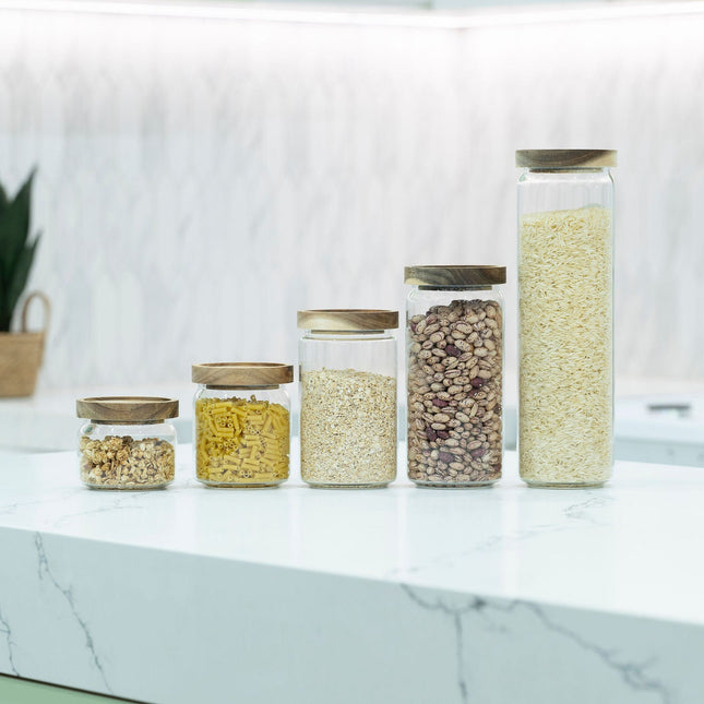 Round Glass Acacia Storage Jar Set – 5 Pack displayed on a kitchen countertop, ideal for pantry organisation and kitchen storage.