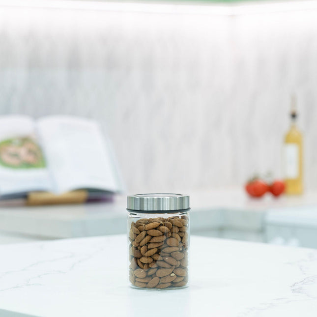 Glass Storage Jar – 550ml with Clear Stainless Lid on kitchen counter for efficient pantry organisation and storage of almonds.