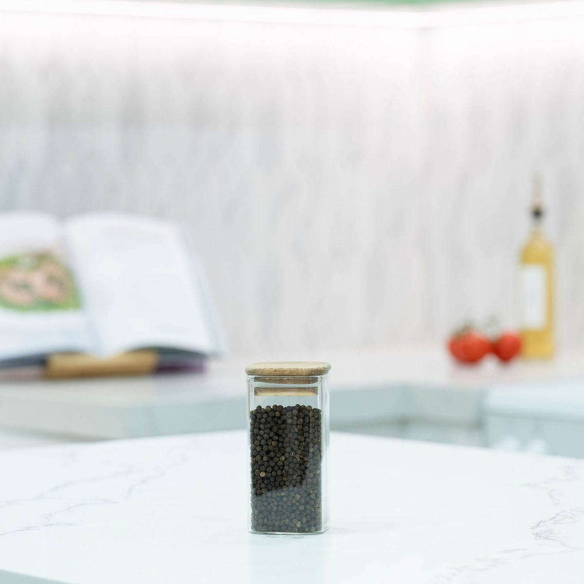 Glass spice jar with wooden lid from Acacia Square Pantry Collection on a kitchen benchtop