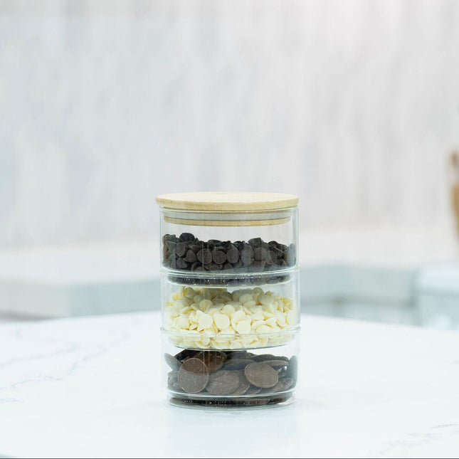 Stackable Round Bamboo Glass Jar – 450ml filled with chocolate chips on kitchen counter; ideal for pantry organisation and storage.