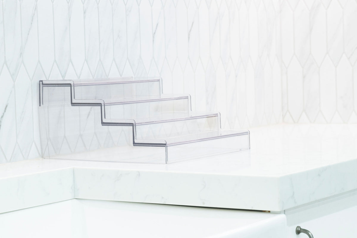 Expandable 4-Tier Clear Spice Rack Organiser on a white kitchen counter, ideal for pantry organisation and maximising storage.