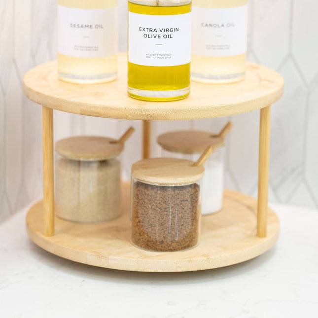 Double-Tier Bamboo Lazy Susan – 30cm Rotating Organiser holding glass jars and oil bottles in kitchen for efficient storage organisers.