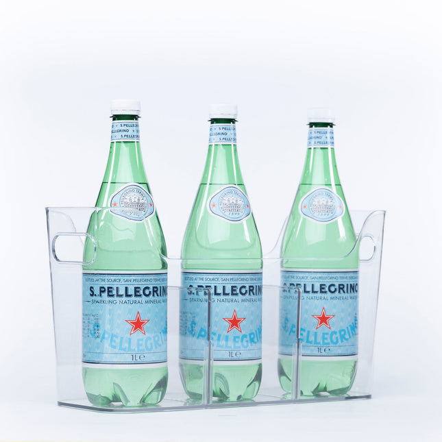 Three bottles of sparkling water stored in a clear Pull-Out Organiser, ideal for kitchen or pantry organisation.