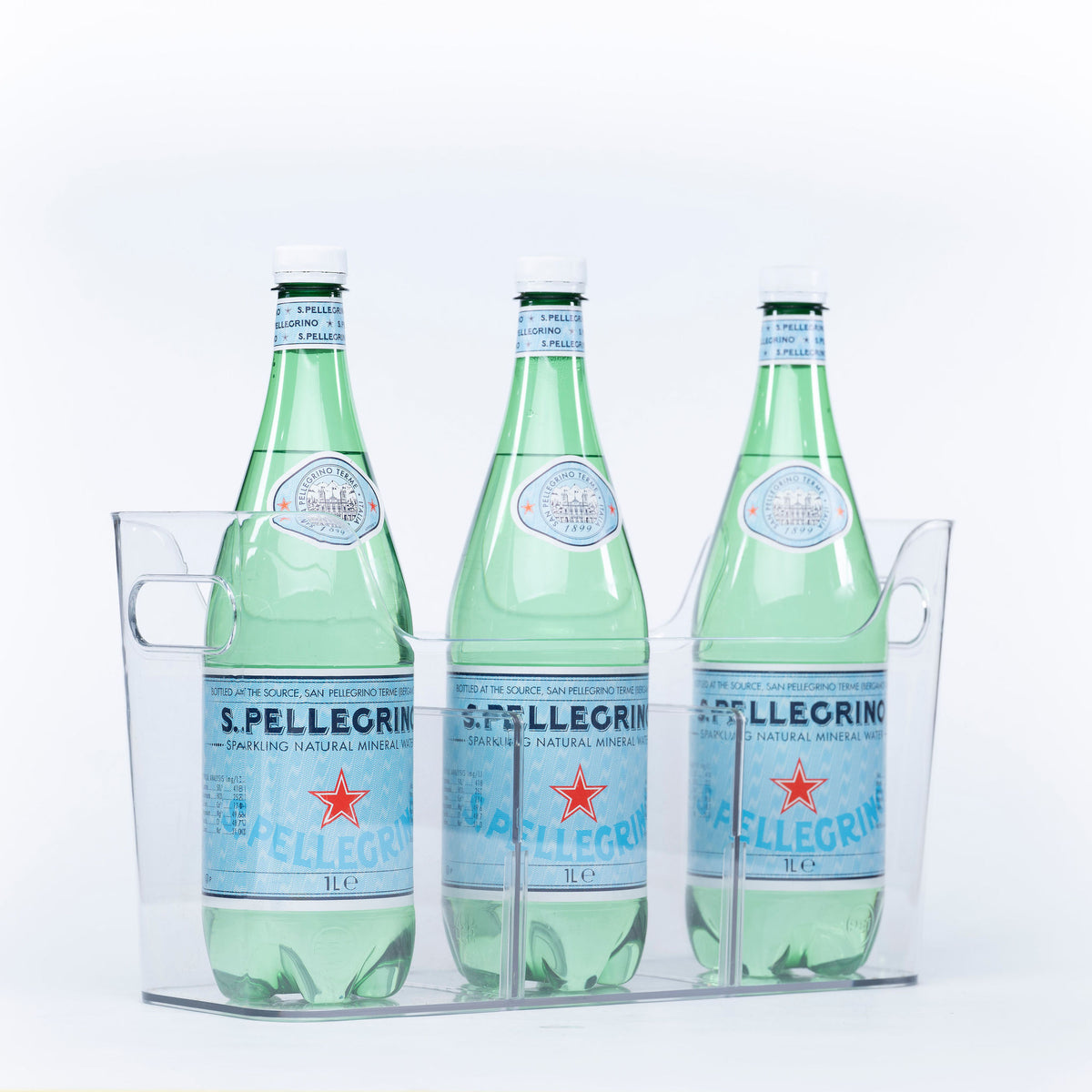 Three bottles of sparkling water stored in a clear Pull-Out Organiser, ideal for kitchen or pantry organisation.
