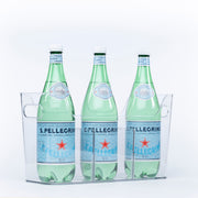 Three bottles of sparkling water stored in a clear Pull-Out Organiser, ideal for kitchen or pantry organisation.